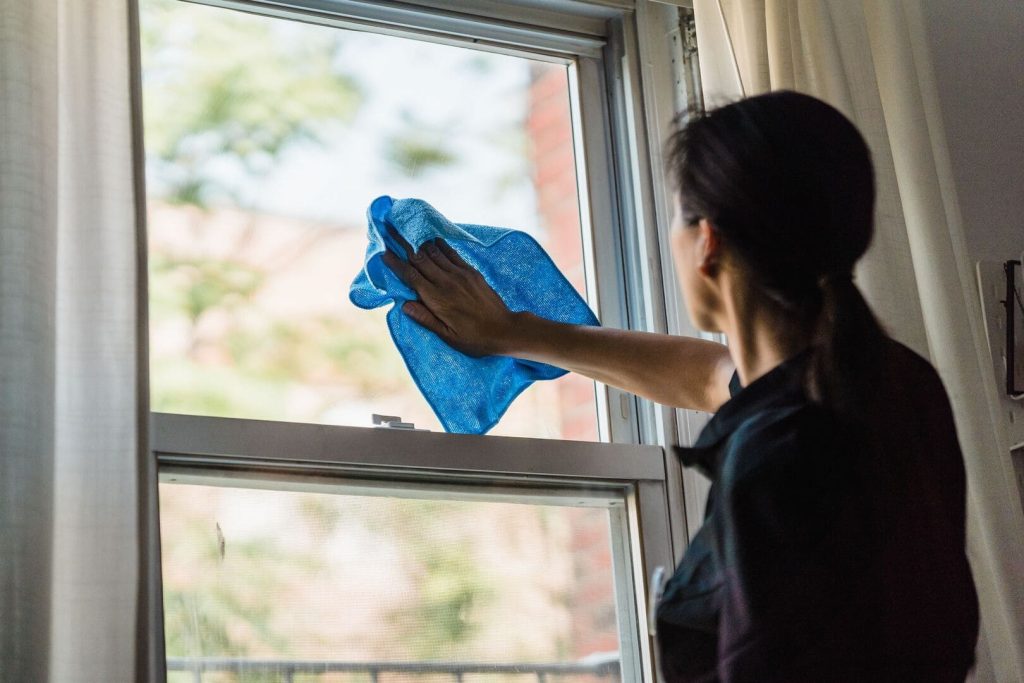 Clendo cleaner polishing glass in an Inner North Canberra apartment near Northbourne Avenue